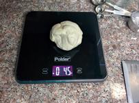 Weighing out one-eighth of the dough.
